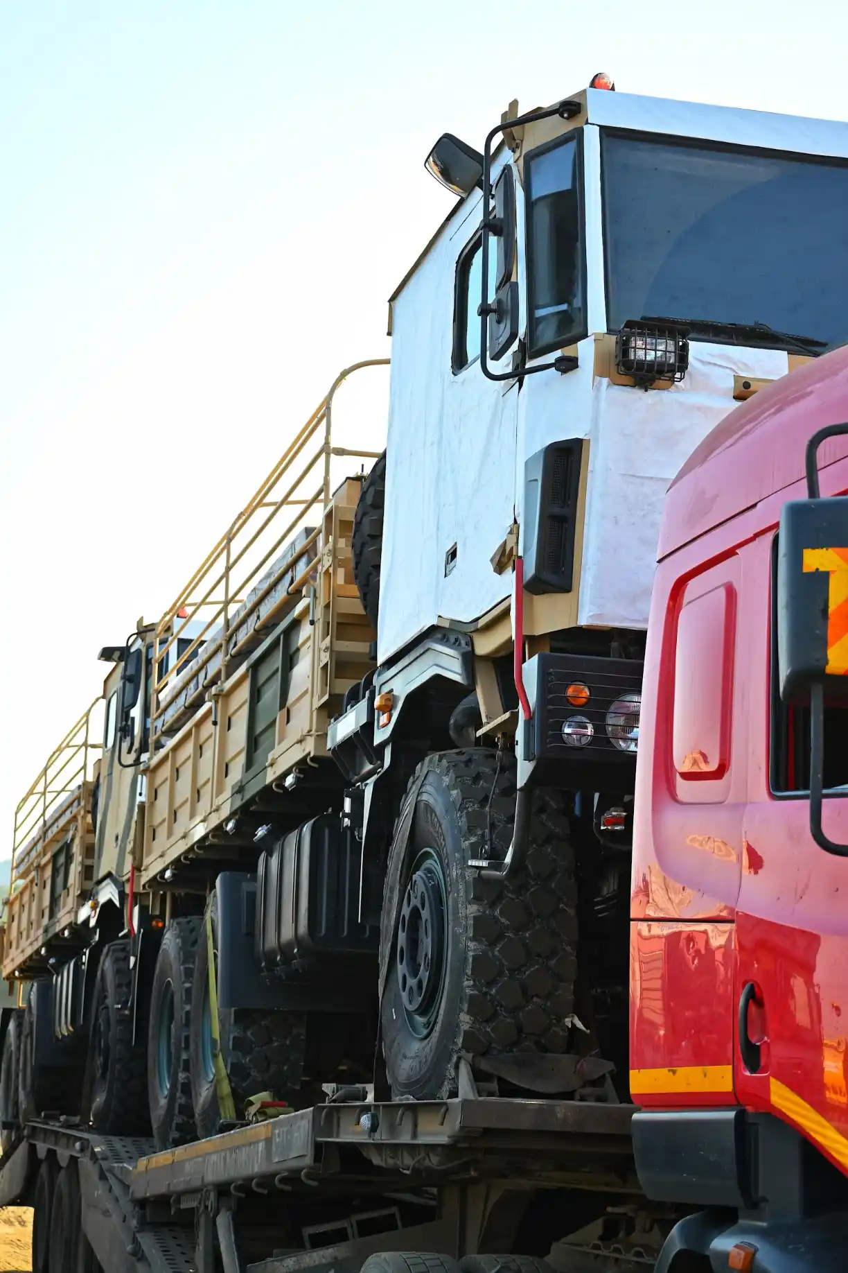 A flatbed tow truck transporting a vehicle through Melbourne, keeping the drivetrain fully clear of the road during transport.