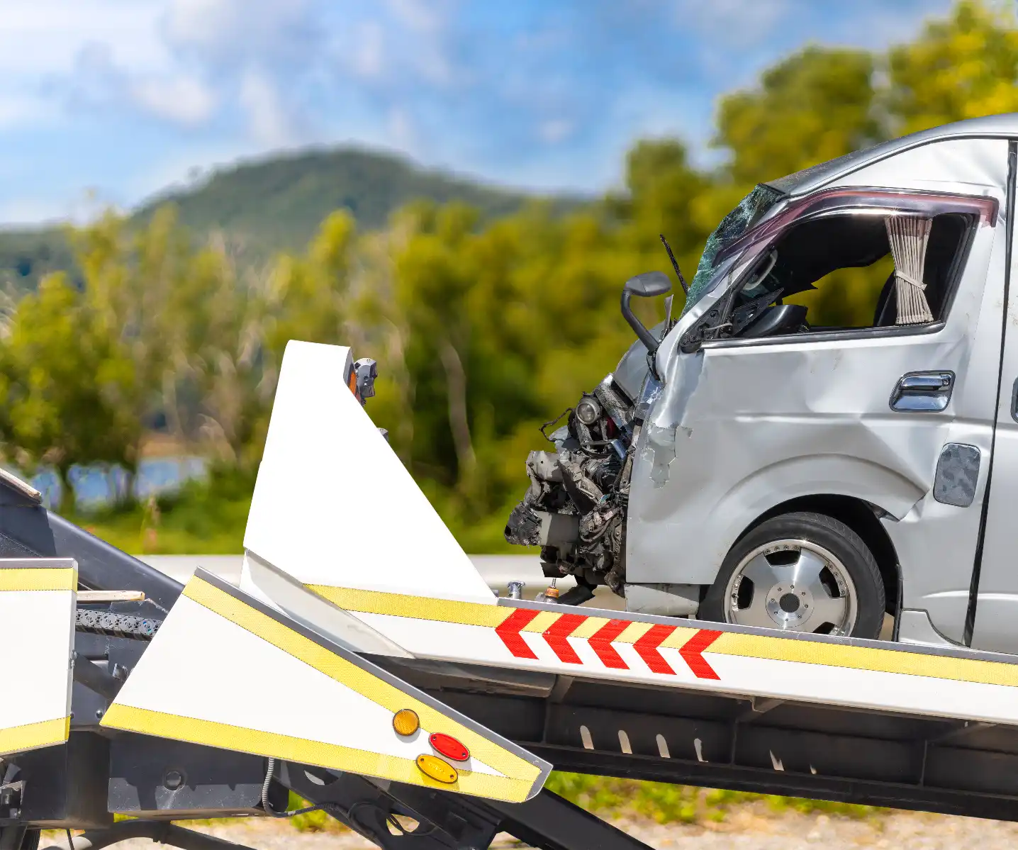 Flatbed tow truck transporting a broken-down SUV on a Melbourne road with fast and reliable 24-hour emergency towing service.
