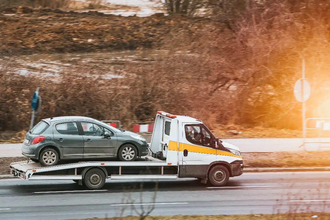 Free Car Removal Melbourne Tow truck operator loading a non-running car for removal
